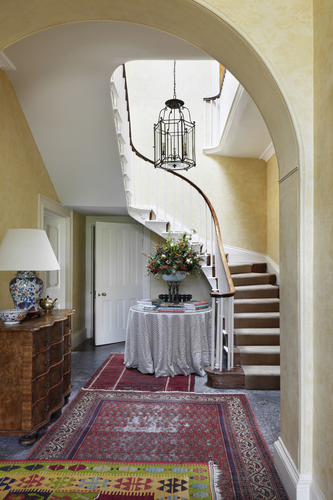 Inspiration for a mid-sized traditional foyer in Dorset with yellow walls and granite floors.