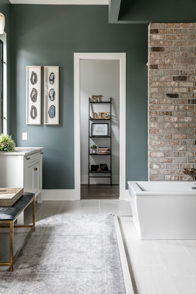 Inspiration for a large transitional master wet room bathroom in New Orleans with recessed-panel cabinets, white cabinets, a freestanding tub, beige tile, stone tile, grey walls, laminate floors, an undermount sink, quartzite benchtops, beige floor, an open shower and white benchtops.
