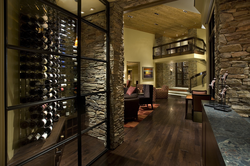 Inspiration for a small contemporary wine cellar in Phoenix with dark hardwood floors, display racks and brown floor.