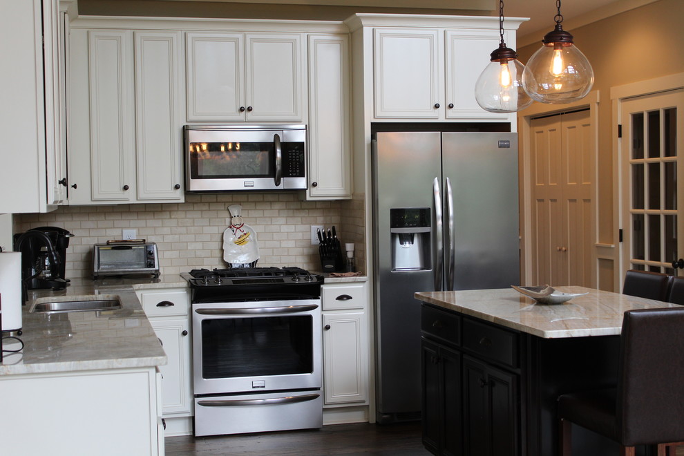 Example of a mid-sized arts and crafts l-shaped dark wood floor and brown floor eat-in kitchen design in Atlanta with an undermount sink, recessed-panel cabinets, white cabinets, quartzite countertops, beige backsplash, subway tile backsplash, stainless steel appliances, an island and beige countertops
