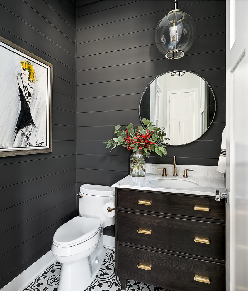 Photo of a country powder room in Chicago with furniture-like cabinets, dark wood cabinets, a one-piece toilet, grey walls, an undermount sink and multi-coloured floor.