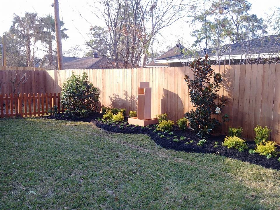 Photo of a mid-sized traditional backyard full sun garden in Houston.