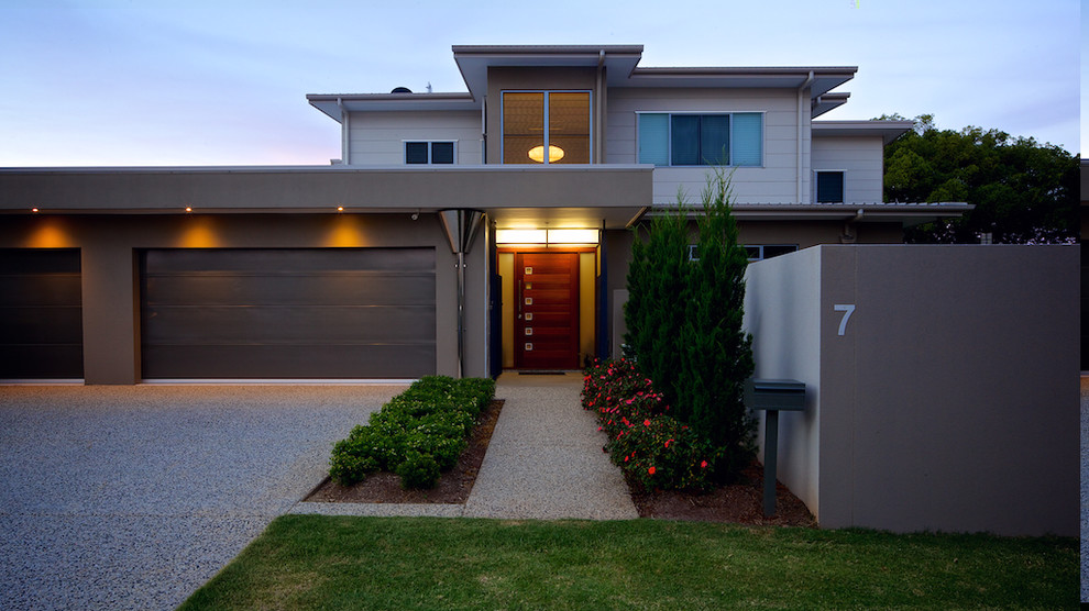 Large contemporary two-storey grey house exterior in Sunshine Coast with a flat roof.