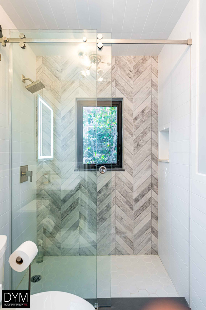 Modern bathroom in Los Angeles with glass-front cabinets, white walls, a hinged shower door, wood, wood walls, gray tile, wood-look tile and beige floor.