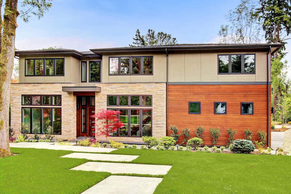 Photo of a contemporary exterior in Seattle with wood siding and a hip roof.