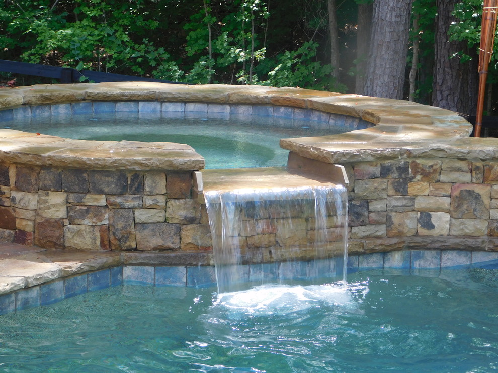 Inspiration for a mid-sized country backyard custom-shaped natural pool in Atlanta with a hot tub.