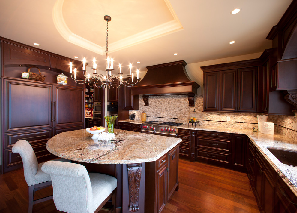 Open concept kitchen - huge rustic u-shaped porcelain tile and beige floor open concept kitchen idea with an undermount sink, raised-panel cabinets, dark wood cabinets, granite countertops, red backsplash, porcelain backsplash, stainless steel appliances and a peninsula