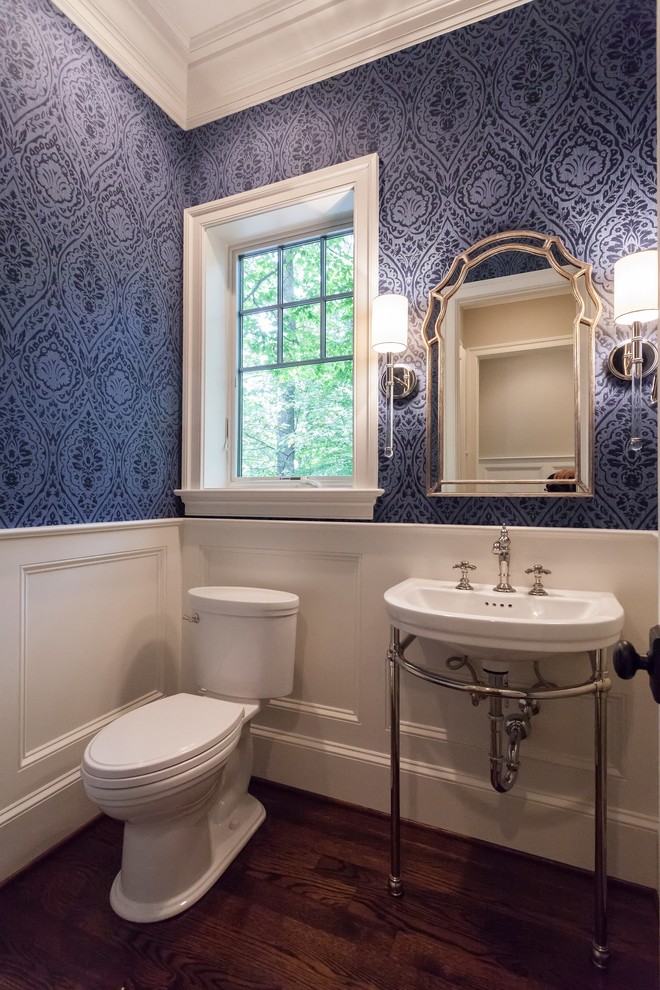 Photo of a traditional powder room in DC Metro with blue walls, medium hardwood floors, a pedestal sink and brown floor.