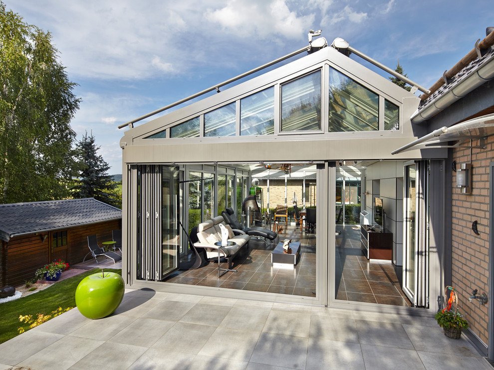 Inspiration for an expansive contemporary sunroom in Other with porcelain floors, a glass ceiling and beige floor.