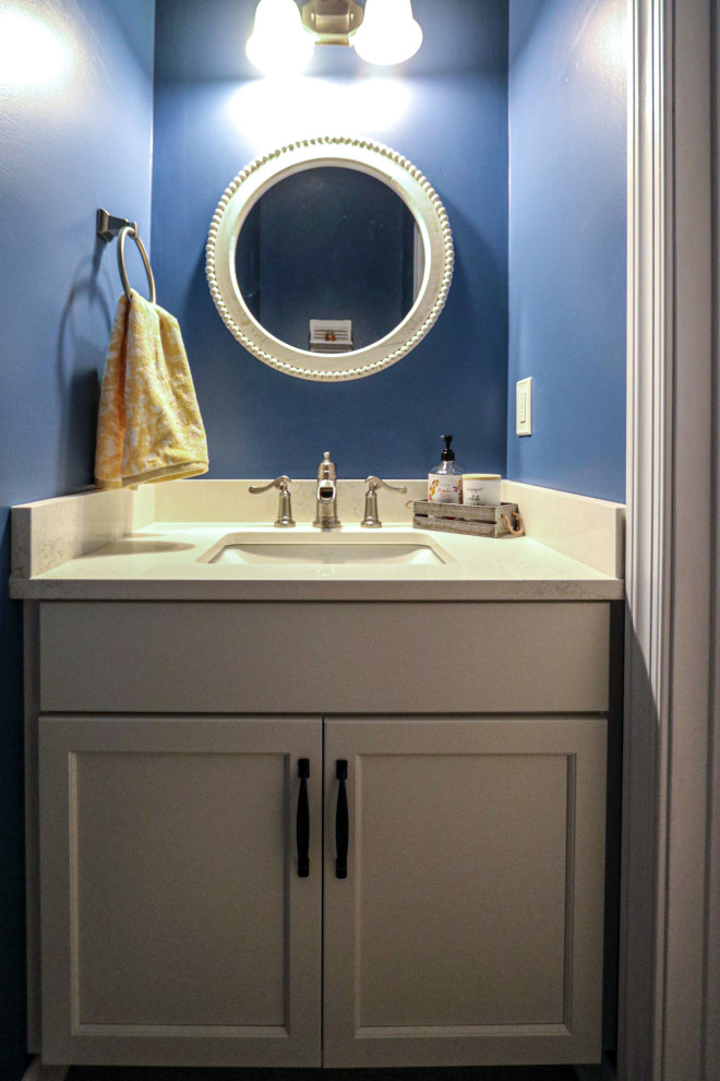 Small traditional cloakroom in Cleveland with flat-panel cabinets, white cabinets, blue walls, medium hardwood flooring, engineered stone worktops, brown floors, white worktops and a freestanding vanity unit.