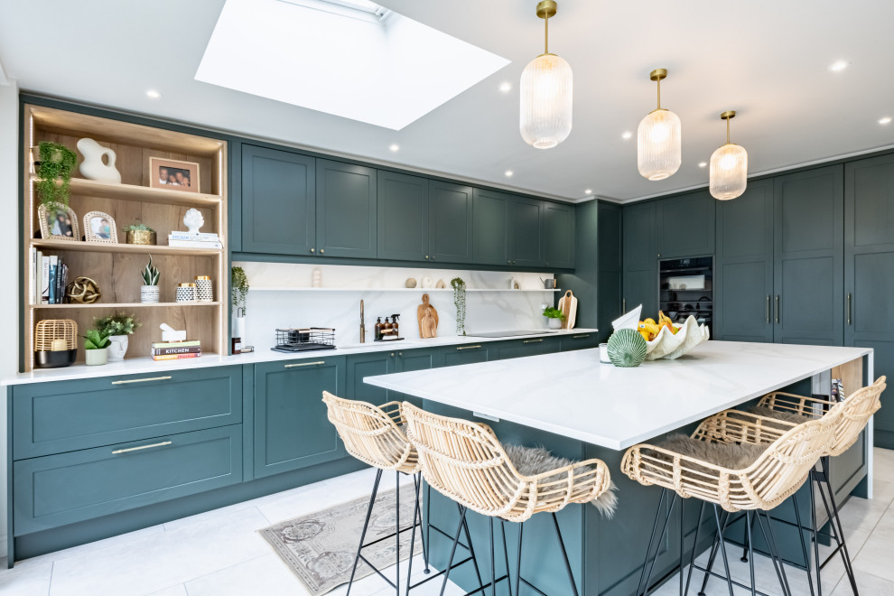 Inspiration for a traditional kitchen in London with shaker cabinets, green cabinets, quartzite benchtops and with island.