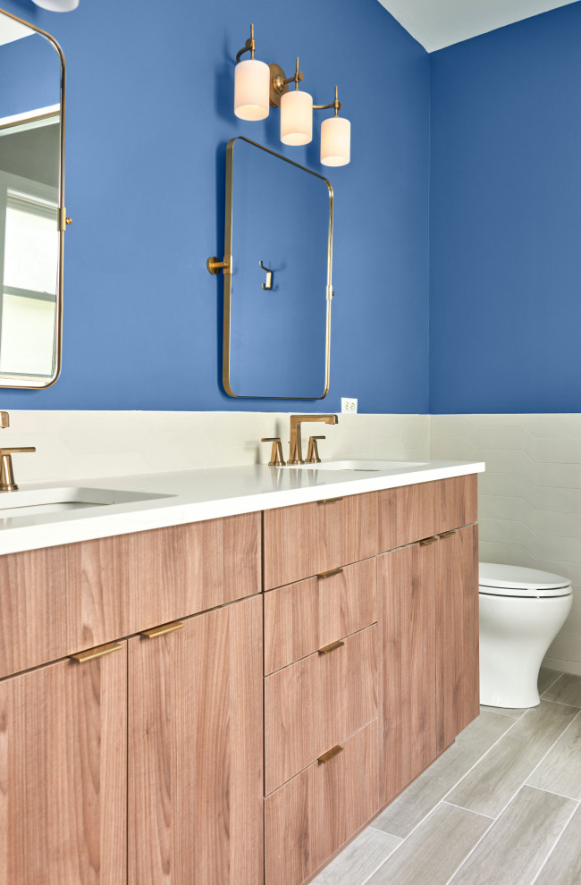 Inspiration for a mid-sized transitional master bathroom in Chicago with light wood cabinets, a freestanding tub, a corner shower, a one-piece toilet, white tile, porcelain tile, blue walls, porcelain floors, a drop-in sink, quartzite benchtops, brown floor, a hinged shower door, white benchtops, a niche, a double vanity and a freestanding vanity.