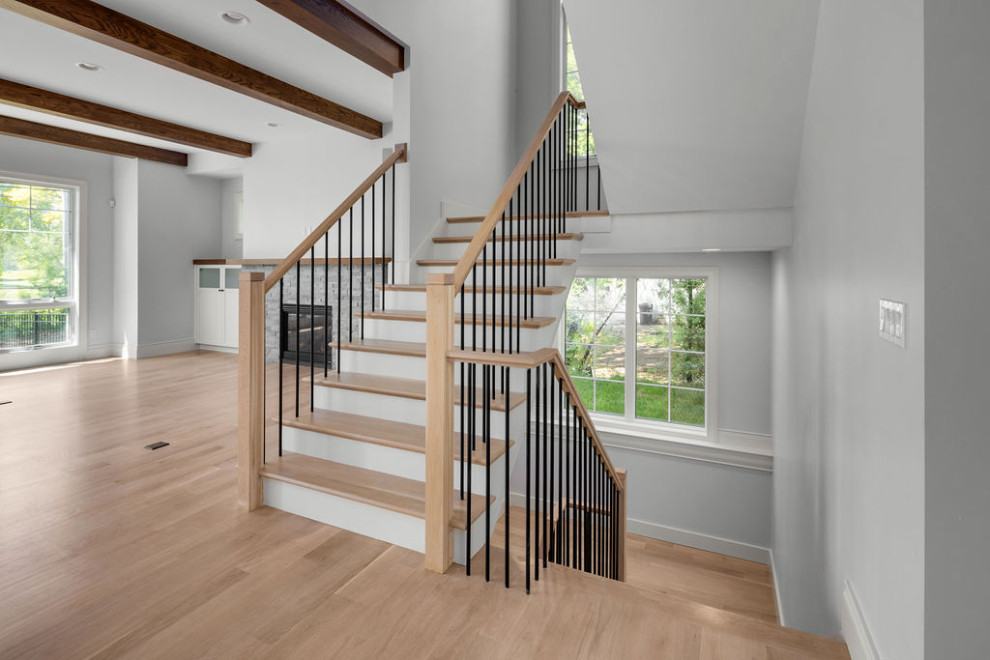 Inspiration for a country wood staircase in Detroit with wood risers and metal railing.