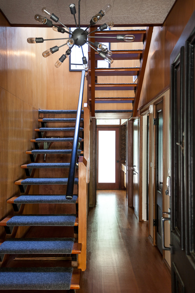 This is an example of a midcentury carpeted l-shaped staircase in Sacramento with open risers.