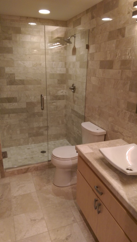 Photo of a mid-sized arts and crafts master bathroom in Minneapolis with a console sink, recessed-panel cabinets, tile benchtops, an alcove shower, a two-piece toilet, stone tile, brown walls, travertine floors and beige tile.
