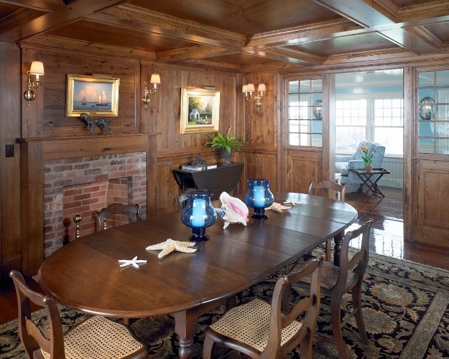 Inspiration for a mid-sized beach style dining room in Boston with dark hardwood floors, a standard fireplace and a brick fireplace surround.