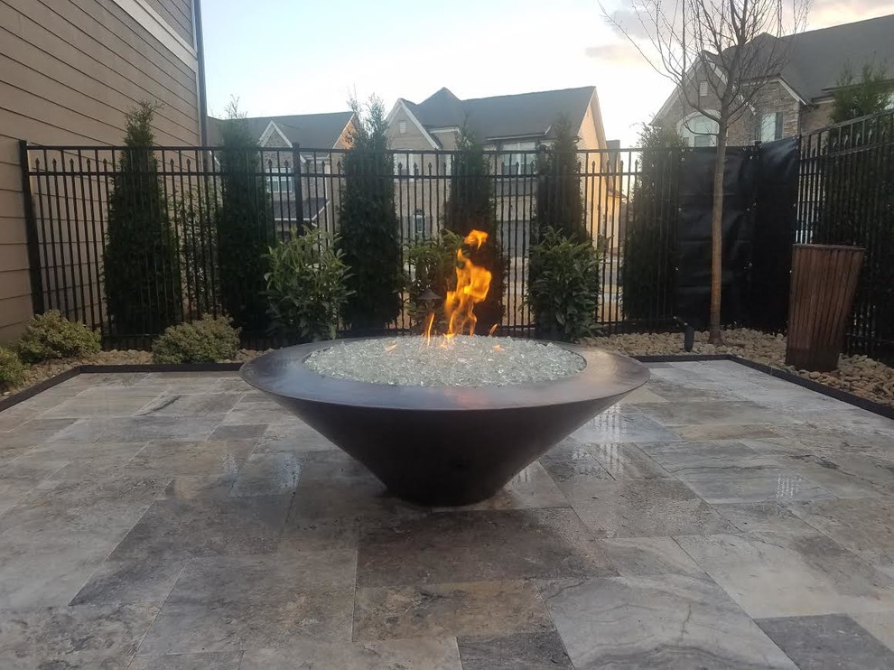 Large traditional backyard patio in Charlotte with a fire feature, stamped concrete and no cover.