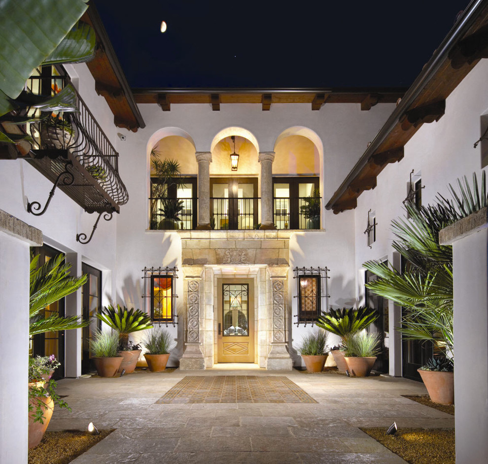 This is an example of a mediterranean entryway in Orange County with a single front door.