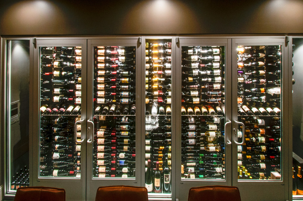 Inspiration for a mid-sized contemporary wine cellar in Nashville with laminate floors, storage racks and grey floor.