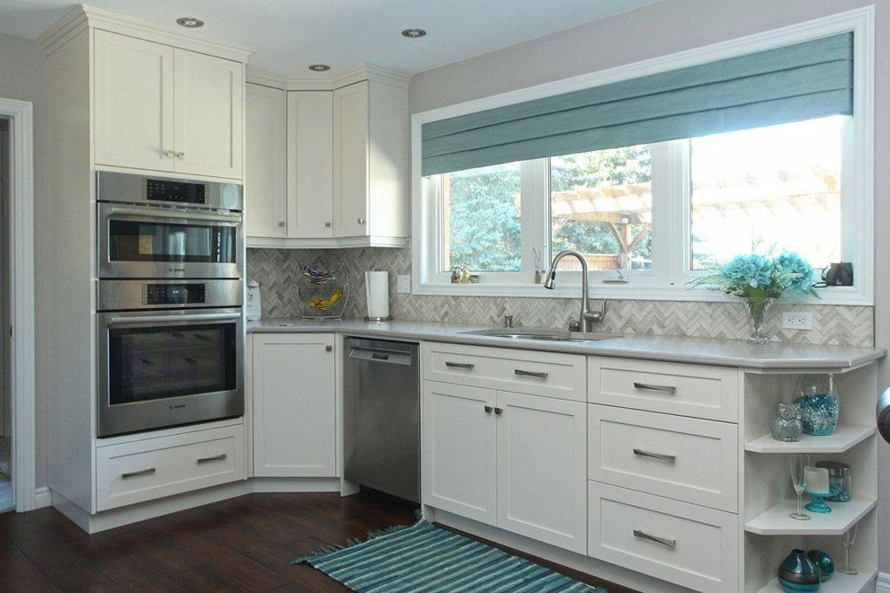 Inspiration for a large transitional dark wood floor and brown floor eat-in kitchen remodel with shaker cabinets, white cabinets, quartz countertops, multicolored backsplash, matchstick tile backsplash, stainless steel appliances, no island and an undermount sink