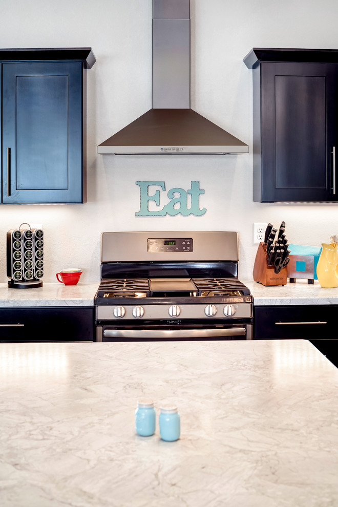 Example of a large transitional l-shaped medium tone wood floor open concept kitchen design with a double-bowl sink, shaker cabinets, dark wood cabinets, quartzite countertops, stainless steel appliances and an island