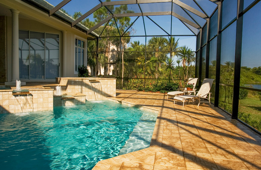 Design ideas for an expansive tropical backyard custom-shaped pool in Miami with tile.