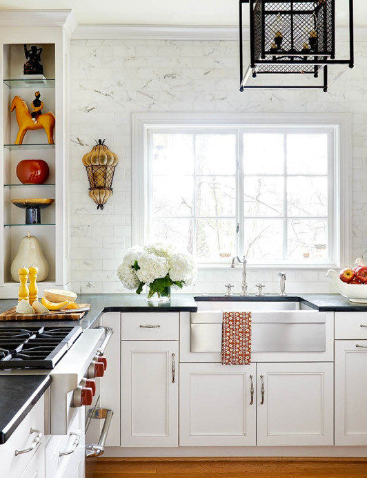 Large transitional u-shaped light wood floor enclosed kitchen photo in Charlotte with a farmhouse sink, recessed-panel cabinets, white cabinets, soapstone countertops, white backsplash, subway tile backsplash and stainless steel appliances