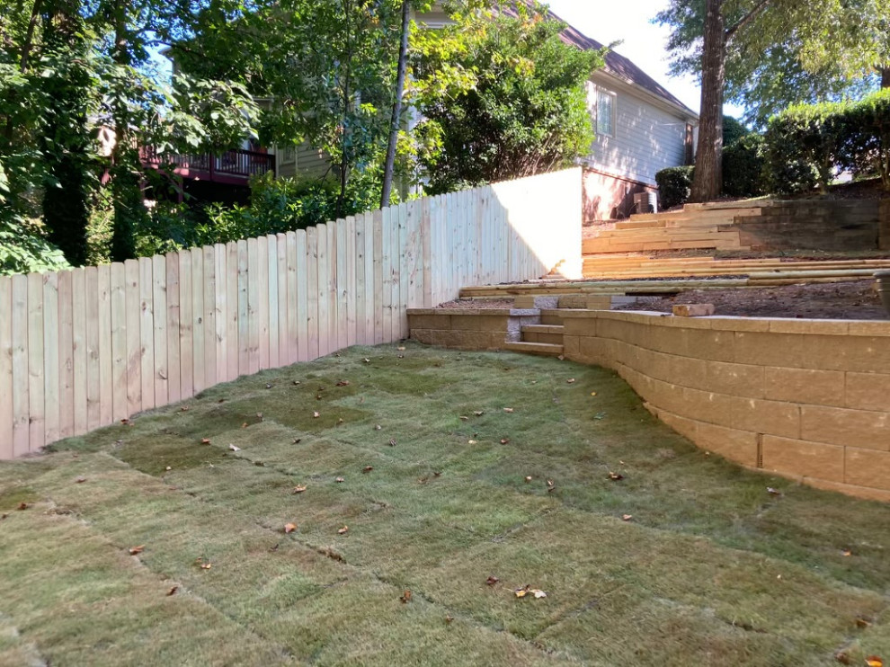 Photo of a modern partial sun backyard wood fence landscaping.