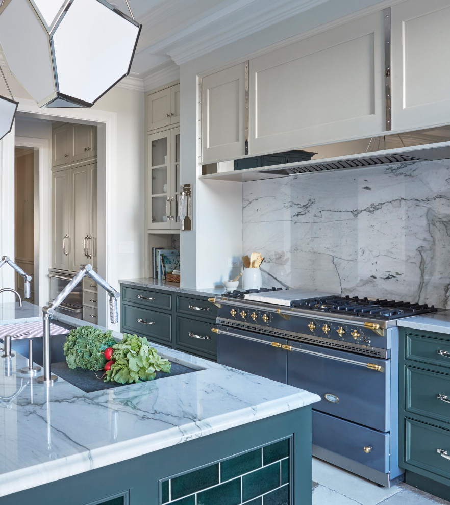 Kitchen photo in Chicago with marble countertops, marble backsplash and an island