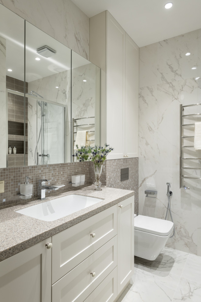 Bathroom - mid-sized transitional 3/4 beige tile and white tile white floor and single-sink bathroom idea in Moscow with recessed-panel cabinets, beige cabinets, a wall-mount toilet, beige walls, an undermount sink, a niche, a freestanding vanity and granite countertops