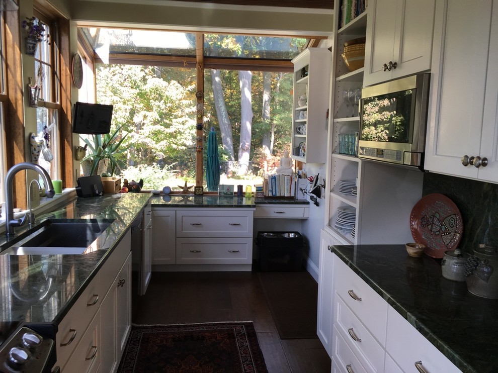Transitional u-shaped dark wood floor kitchen photo in Boston with an undermount sink, shaker cabinets, white cabinets, granite countertops and stainless steel appliances