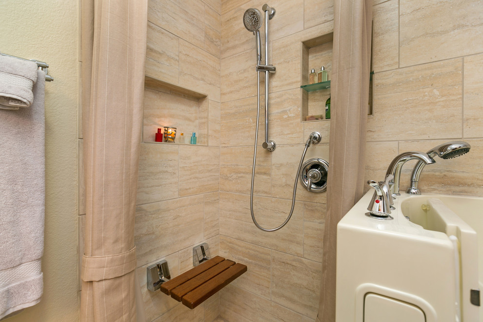 This is an example of a large asian master bathroom in San Diego with recessed-panel cabinets, light wood cabinets, a corner tub, a corner shower, a two-piece toilet, beige tile, travertine, beige walls, porcelain floors, a vessel sink and granite benchtops.