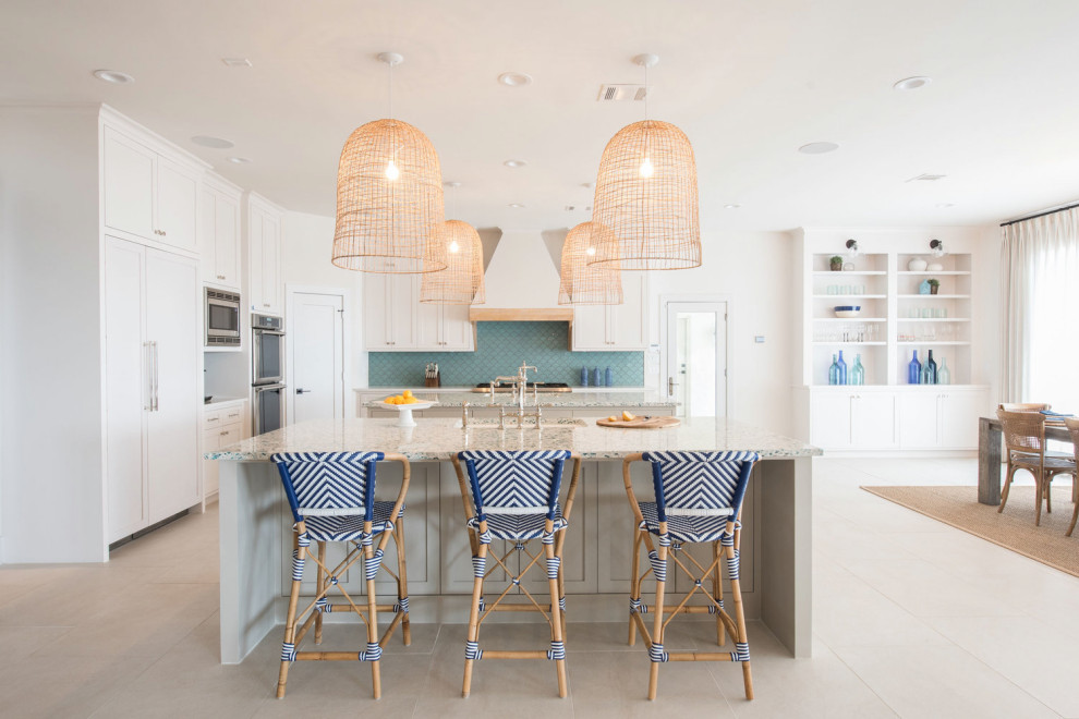 Inspiration for a large beach style u-shaped eat-in kitchen in Houston with a drop-in sink, white cabinets, recycled glass benchtops, blue splashback, mosaic tile splashback, stainless steel appliances, multiple islands and multi-coloured benchtop.