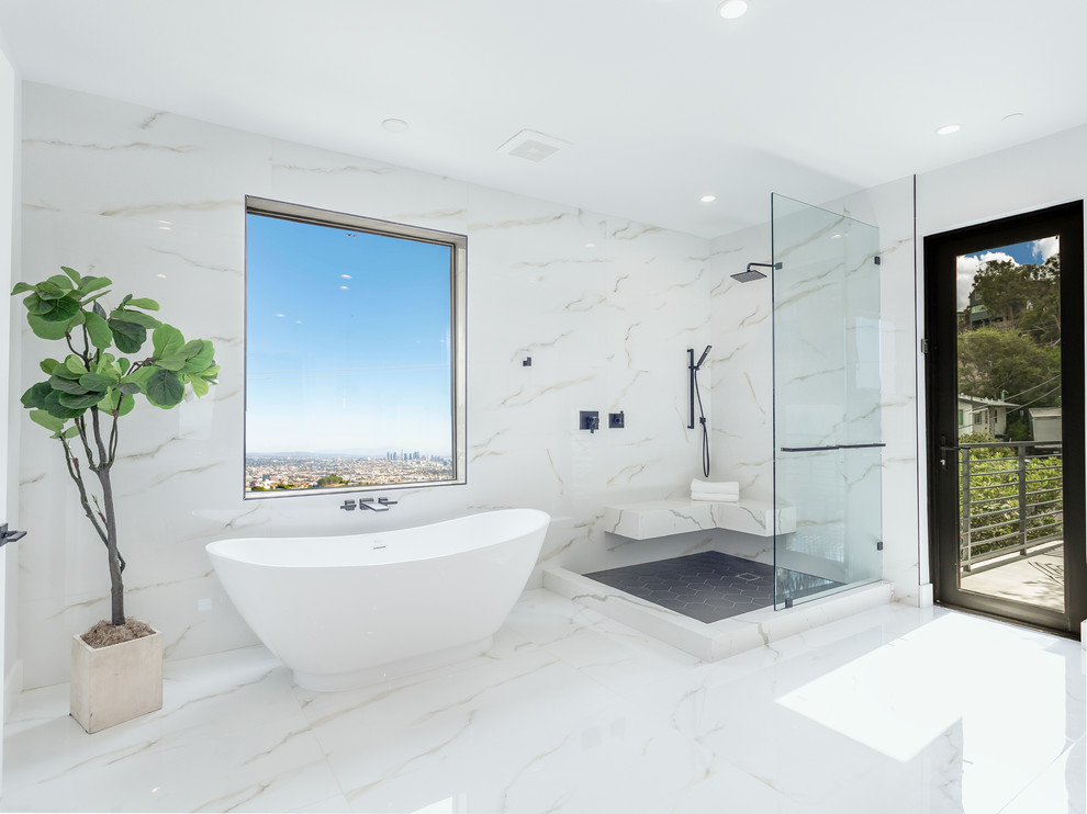 Design ideas for an expansive midcentury master bathroom in Los Angeles with a freestanding tub, a corner shower, white floor, white benchtops, white tile, white walls, an open shower, marble floors and a shower seat.