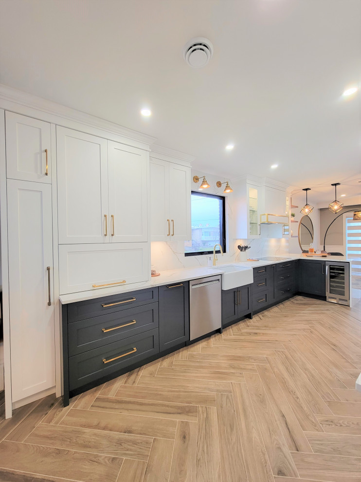 Example of a mid-sized transitional galley porcelain tile and brown floor eat-in kitchen design in Montreal with an undermount sink, shaker cabinets, blue cabinets, quartz countertops, white backsplash, quartz backsplash, stainless steel appliances, a peninsula and white countertops