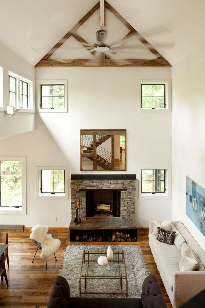 Inspiration for a contemporary living room in New York with a stone fireplace surround.