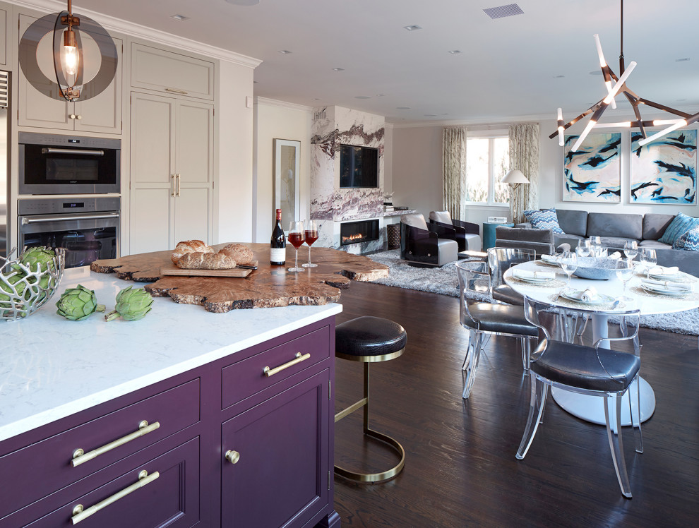 Design ideas for an expansive eclectic u-shaped eat-in kitchen in New York with an undermount sink, recessed-panel cabinets, quartz benchtops, metallic splashback, metal splashback, stainless steel appliances, dark hardwood floors, with island, brown floor, white benchtop and purple cabinets.