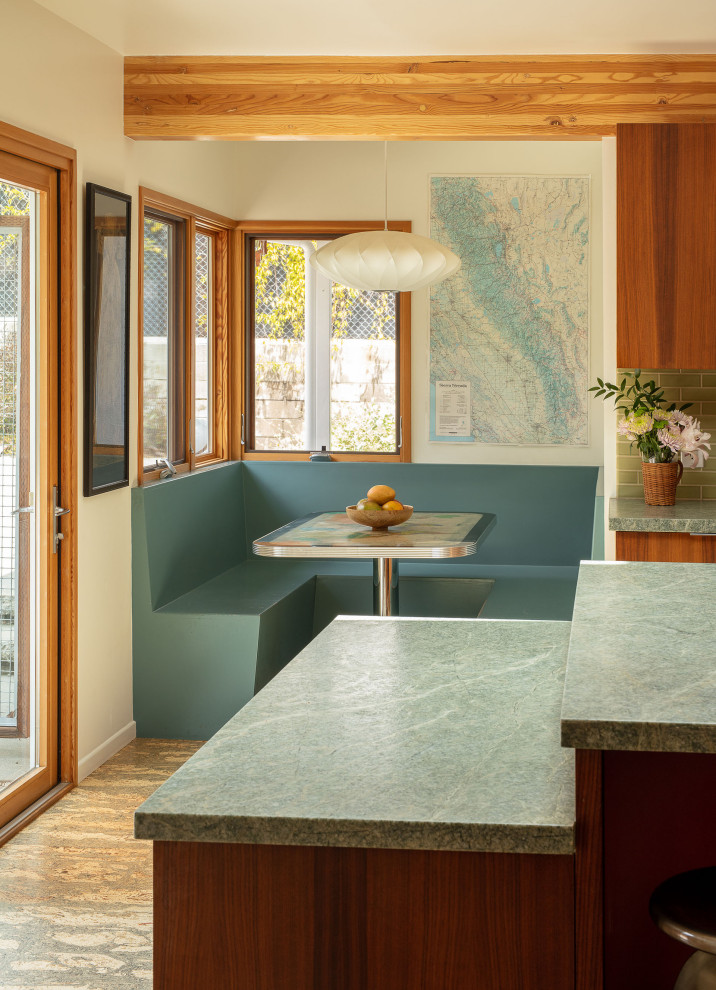 Design ideas for a large midcentury l-shaped eat-in kitchen in Los Angeles with a double-bowl sink, flat-panel cabinets, dark wood cabinets, quartzite benchtops, green splashback, subway tile splashback, stainless steel appliances, cork floors, with island, beige floor, grey benchtop and exposed beam.