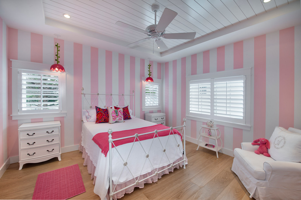 Inspiration for a beach style kids' bedroom for kids 4-10 years old and girls in Miami with light hardwood floors and multi-coloured walls.
