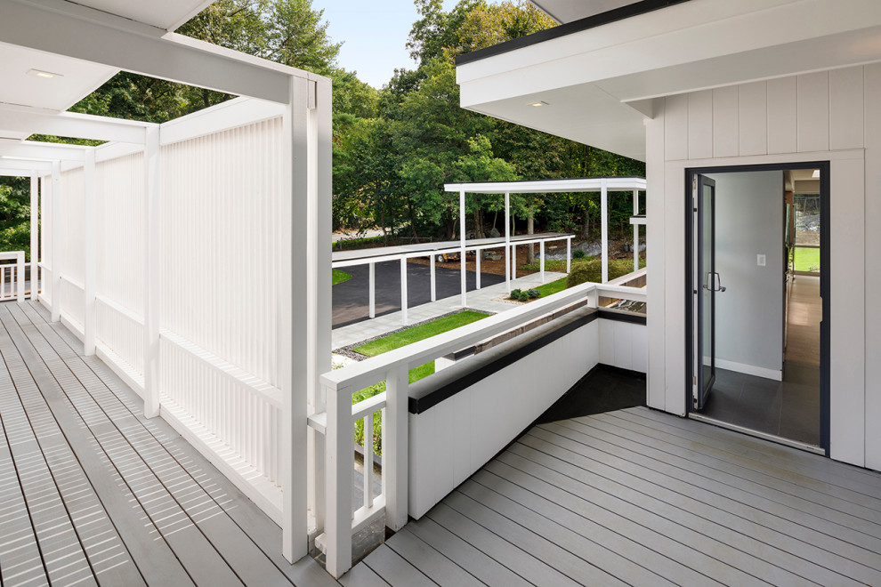Photo of a large contemporary roof first floor wood railing terrace in New York with a roof extension.