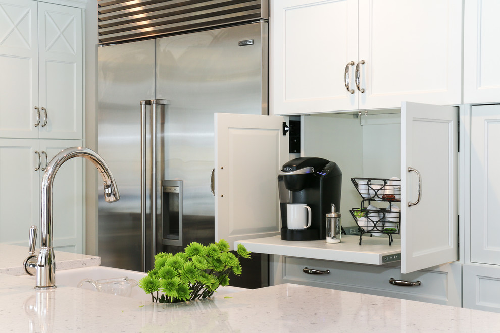 Inspiration for a large transitional u-shaped dark wood floor and brown floor kitchen remodel in Chicago with a farmhouse sink, recessed-panel cabinets, white cabinets, quartzite countertops, stainless steel appliances and an island