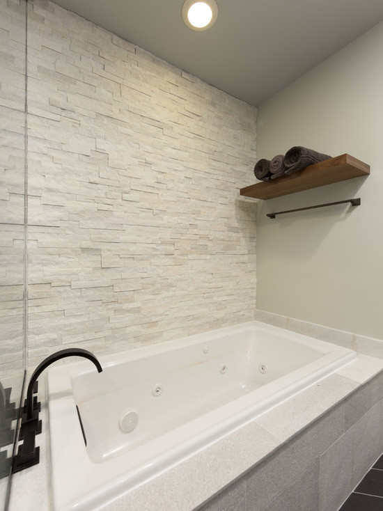 Design ideas for a mid-sized transitional master bathroom in Chicago with flat-panel cabinets, medium wood cabinets, a drop-in tub, an alcove shower, a one-piece toilet, black and white tile, marble, beige walls, ceramic floors, an undermount sink and limestone benchtops.