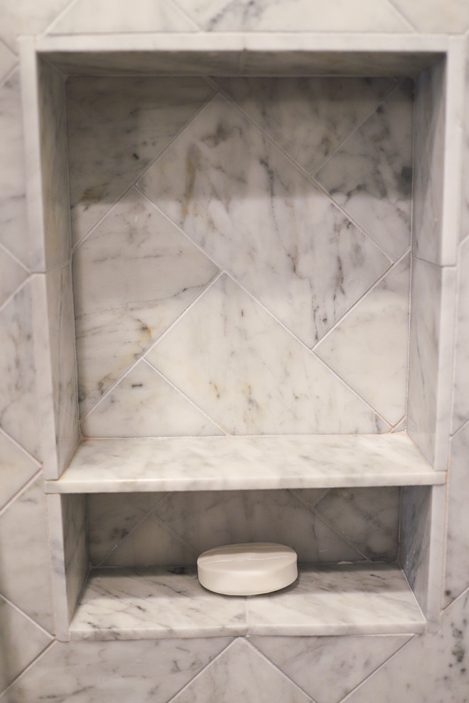 Corner shower - large transitional master white tile and marble tile porcelain tile and gray floor corner shower idea with shaker cabinets, dark wood cabinets, an undermount tub, a one-piece toilet, brown walls, an undermount sink, quartz countertops, a hinged shower door and white countertops