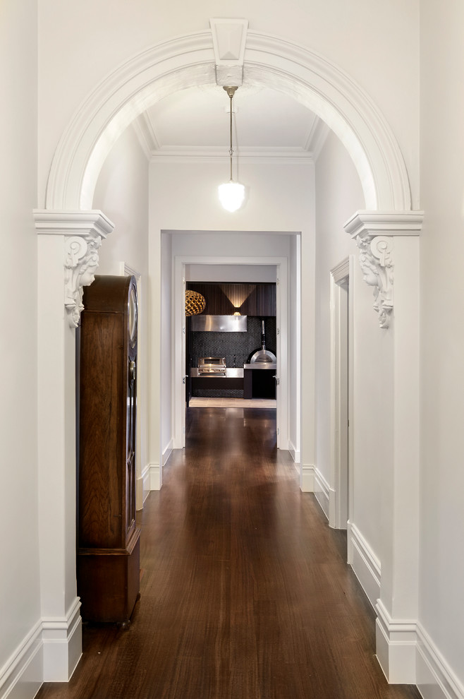 This is an example of a traditional hallway in Melbourne with dark hardwood floors.