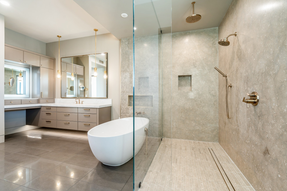 Design ideas for an expansive contemporary master bathroom in Phoenix with flat-panel cabinets, beige cabinets, a freestanding tub, an open shower, a one-piece toilet, white tile, stone slab, beige walls, porcelain floors, a drop-in sink, limestone benchtops, brown floor, an open shower, white benchtops, an enclosed toilet, a double vanity, a floating vanity, vaulted and panelled walls.