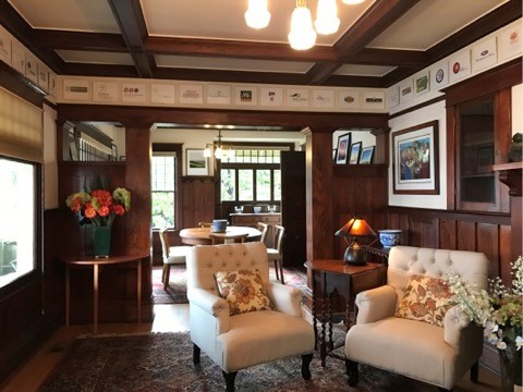 Photo of a large traditional formal open concept living room in Portland with white walls, medium hardwood floors, a standard fireplace, a tile fireplace surround, no tv and brown floor.