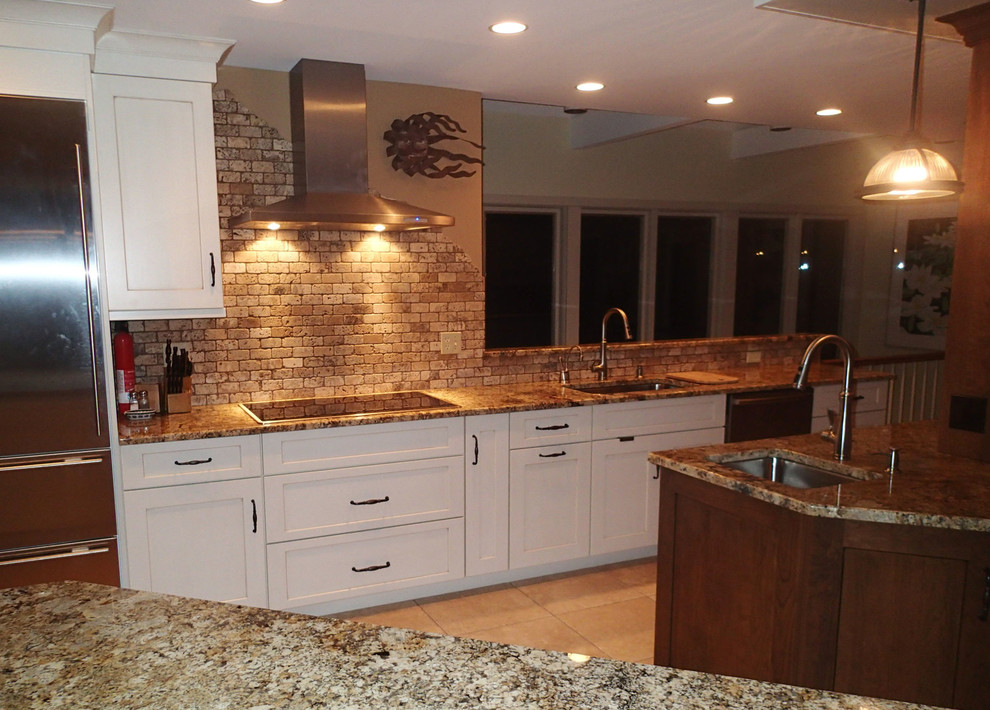 Example of a large mountain style ceramic tile eat-in kitchen design in Bridgeport with an undermount sink, shaker cabinets, granite countertops, beige backsplash, stone tile backsplash, stainless steel appliances and an island