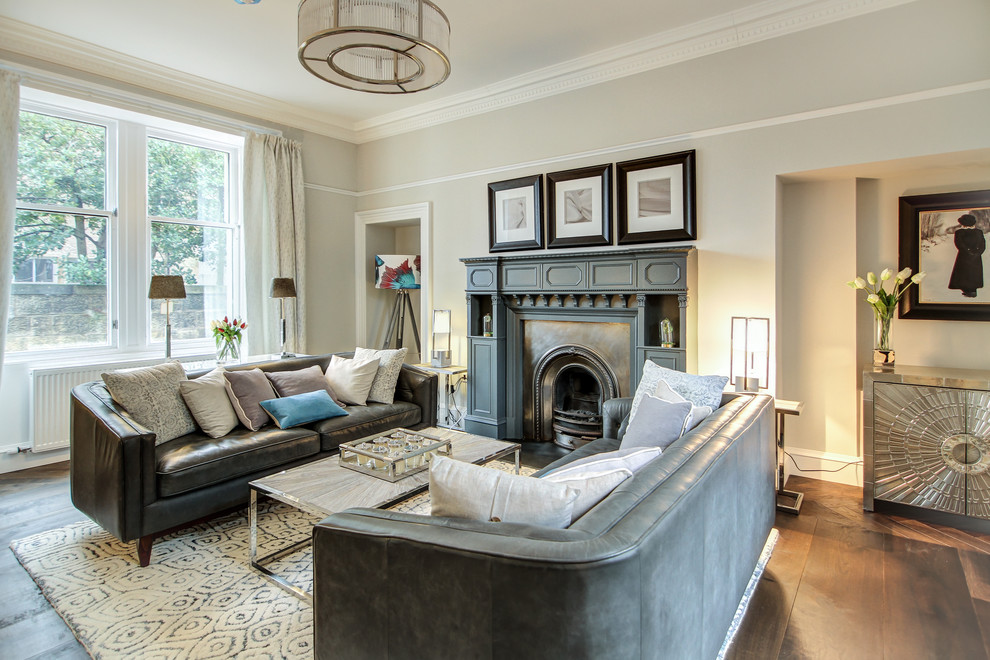 Large transitional formal enclosed living room in Edinburgh with dark hardwood floors, a standard fireplace, a metal fireplace surround, brown floor and beige walls.
