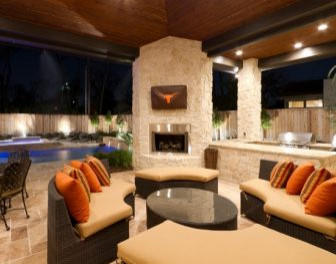 covered patio with fireplace and seats
