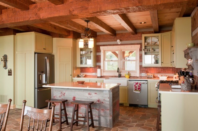 Open concept kitchen - large rustic slate floor open concept kitchen idea with a drop-in sink, shaker cabinets, green cabinets, quartzite countertops, brown backsplash, stainless steel appliances and an island